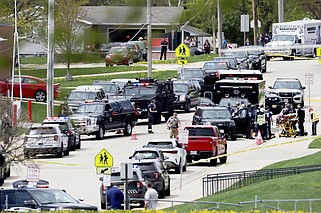 Law enforcement personnel respond to a report of a person armed with a rifle at Mount Horeb Middle School in Mount Horeb, Wis., Wednesday, May 1, 2024.  The school district said a person it described as an active shooter was outside a middle school in Mount Horeb on Wednesday but the threat was &#x201c;neutralized&#x201d; and no one inside the building was injured. (John Hart/Wisconsin State Journal via AP)